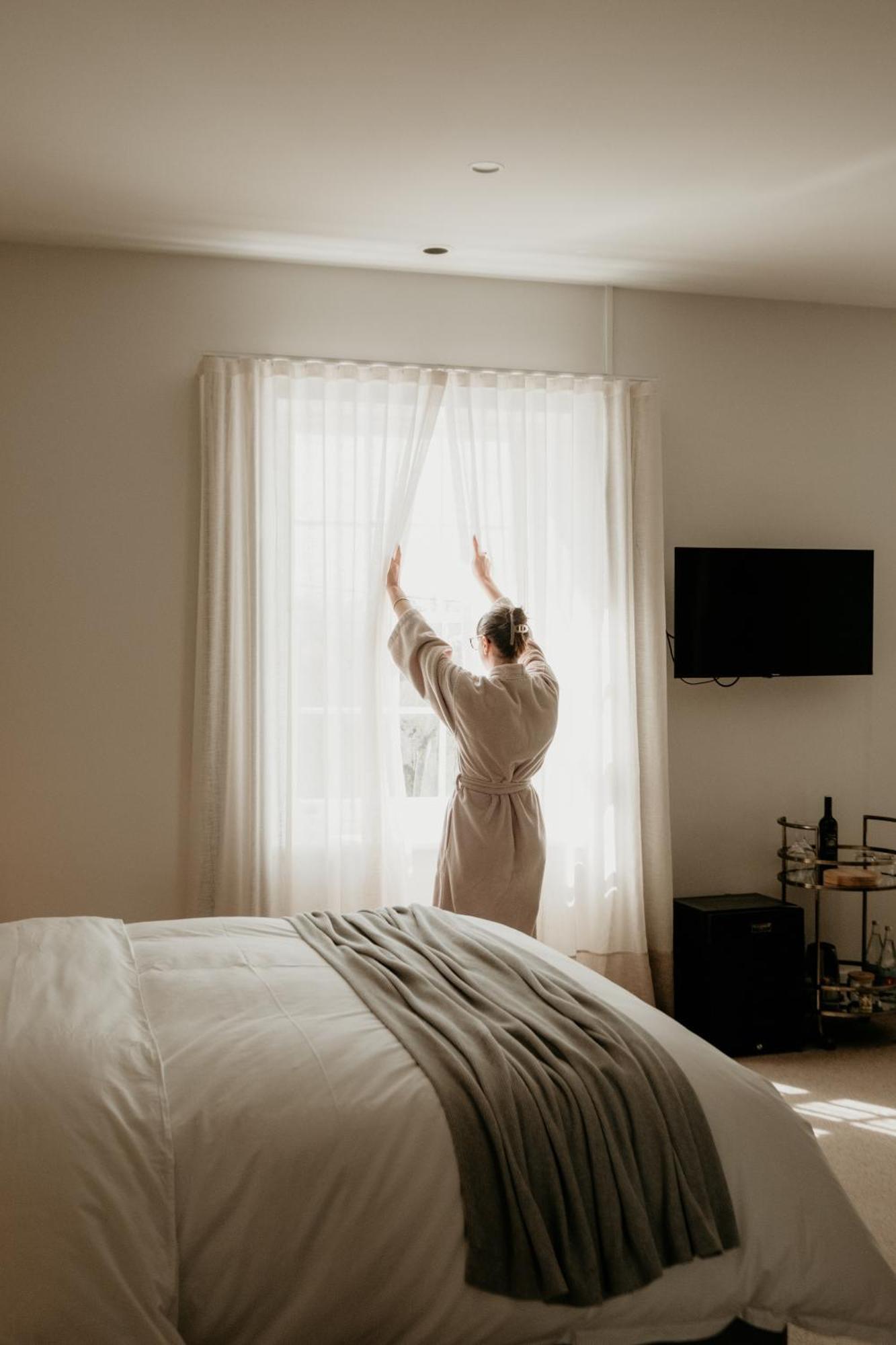 The Oak & Anchor Hotel Port Fairy Exterior photo A woman opening the curtains in the morning